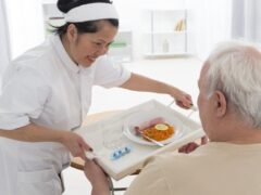 senior man eats lunch at retirement home (care, home, elderly)